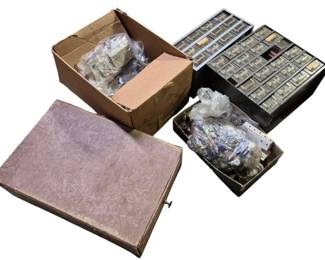 4112 - Group Lot of Sewing Supplies w/ Organizers (Description): Group lot of sewing supplies including two  multi-drawer organizer cabinets filled with  various notions, along with cardboard boxes  containing additional sewing materials  wrapped in plastic bags. The organizers feature multiple small pull-out drawers for  sorting and storing small items such as  buttons, beads, and other sewing accessories.