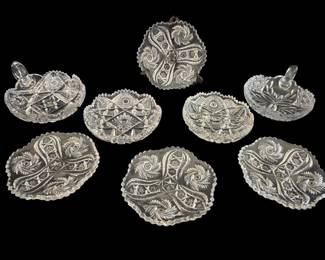 475 - 8 Piece Lot of Cut Glass (Description): A lot of eight cut glass pieces featuring  various decorative patterns. The collection  includes bowls and dishes with intricate cut  designs and sawtooth edges.