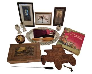 4049 - Group Lot of Collectibles & Decorative Items (Description): A diverse group lot of collectibles and  decorative items including three framed  artworks featuring a portrait, a bird print,  and a nautical scene. The lot also contains a  copy of Winnie-the-Pooh by A.A. Milne with illustrations by Ernest H. Shepard,a carved  wooden box with pastoral scene inlay, a  wooden antique car wall plaque, an oval glass  serving tray with rope-twist border, vanity  items including brushes and a hand mirror,