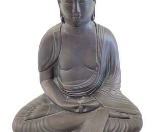 433 - Stone Buddha Statue 13"x10.5" (Description): Stone Buddha statue depicting a seated figure  in traditional meditation pose. The Buddha  is shown in dhyana mudra with hands resting  in the lap, wearing flowing robes draped over  one shoulder. Features include a serene expression with closed eyes, elongated  earlobes, and the characteristic ushnisha  (cranial bump) with textured curls. The  figure sits cross-legged on a lotus-style  base. Finished in a dark matte gray tone.