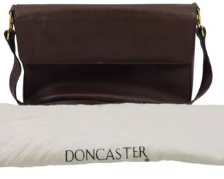 1828 - Doncaster Leather Flap Shoulder Bag 8"x12"x4" (Description): Doncaster leather flap shoulder bag featuring  a fold-over flap closure and adjustable  shoulder strap with brass-tone hardware.  Includes original Doncaster dust bag for  storage. Measures 8 inches high by 12 inches wide by 4 inches deep.