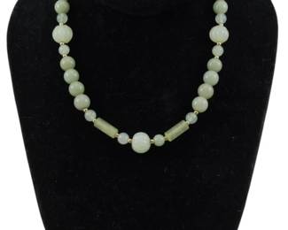 1891 - Jade Necklace w/ Silver Clasp (Description): Jade necklace featuring a clasp marked  silver. The necklace is composed of jade  beads with gold-tone spacers and includes a  central carved jade bead accent.