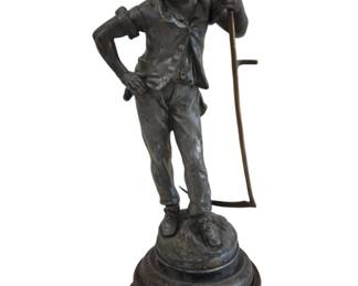 548 - Dans les Pres Spelter Statue w/ Wood Base (Description): Dans les Pres spelter statue depicting a  young boy in period clothing, standing in a  casual pose with one hand on his hip and the  other holding a rake. The figure has curly  hair and wears a vest over a shirt with rolled-up trousers and period shoes. The  statue rests on a stepped circular base  mounted to a carved wooden stand. Measures 21  inches tall.