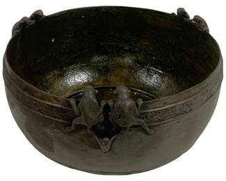 8004 - Bronze Monkey Bowl Planter 12"x20" (Description): A distinctive bronze bowl planter featuring  decorative monkey figures perched along the  rim. The bowl showcases an ornate band of  scrolling floral motifs encircling the  exterior, with pairs of playful monkeys positioned at intervals around the  edge,appearing to peer into the vessel. The  bronze has developed a rich, dark patina with  subtle greenish undertones on the interior.  Measures 20 inches in diameter by 12 inches