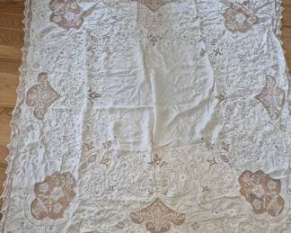 1310 - Vtg White Lace Cutwork Tablecloth 94x58 (Description): Vintage white lace tablecloth featuring  intricate cutwork and embroidered floral  designs throughout. The piece displays  delicate scrollwork patterns and ornate  medallion motifs in the corners and borders, with a scalloped lace edge. The tablecloth  measures 94 inches by 58 inches.
