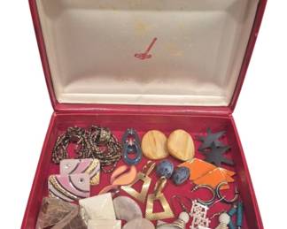 1973 - Assorted Costume Earrings in Red Jewelry Box (Description): A collection of assorted costume earrings  housed in a red leather jewelry box with  cream satin-lined interior. The assortment  includes a variety of styles from different  eras, featuring materials such as wood, enamel, metal, mother of pearl, and shell.  Styles range from geometric and abstract  designs to figural motifs including fish and  flamingos. Various finishes include  gold-tone, silver-tone, and painted elements