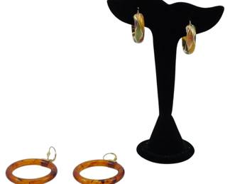 1948 - 2 Pairs of Gold Accent Vintage Earrings (Description): The lot includes two distinct styles, both  featuring lever-back closures with gold  accents. These earrings showcase the  characteristic warmth and translucency  popular in vintage jewelry.
