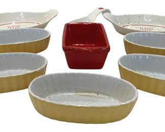 935 - Ceramic Baking Dishes & Serving Bowls Lot (Description): Collection of ceramic baking dishes and  serving pieces. Includes five yellow and  white ribbed oval baking dishes, two white  gravy boats or sauce dishes marked "Kiss the  Cook" with red accents, one red square ramekin, and one spoon rest.