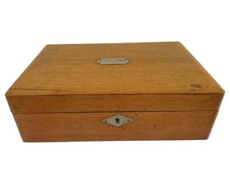 404 - Antique Oak Lap Desk 11.5"x8"x3.75" (Description): Antique oak lap desk featuring a rectangular  form with brass hardware. The lid is fitted  with a blank brass nameplate, and the front  displays a diamond-shaped brass escutcheon  with keyhole. The wood shows warm honey-toned patina consistent with age.