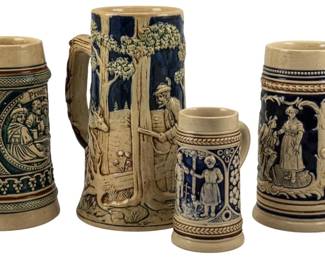745 - 4 Vintage Stein Mugs, Largest: 8" (Description): Collection of four vintage ceramic steins  without lids. The steins feature traditional  German-style relief decorations with figural  scenes. The largest stein measures 8 inches  tall.