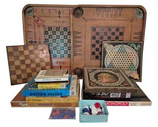 3793 - Group Lot of Vintage Games (Description): A group lot of vintage games including a  large wooden multi-game board featuring  checkers, backgammon, and other classic  games. The collection also includes a Chinese  Checkers board, a decorative inlaid wooden game box, a small wooden chess/checkerboard,  Monopoly, Parcheesi, Sea Treasures, Old Maid  card game, Astral Tarot cards, an Authentic  Map of the United States game, a silhouette  jigsaw puzzle, and assorted game pieces
