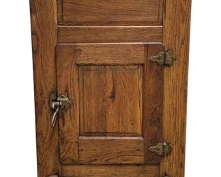 3956 - Antique Oak Ice Box 39"x22"x16" (Description): Antique oak ice box featuring two doors with  raised panel construction and original brass  hardware including decorative hinges and a  latch handle. The piece has a warm golden oak  finish with beautiful wood grain visible throughout.