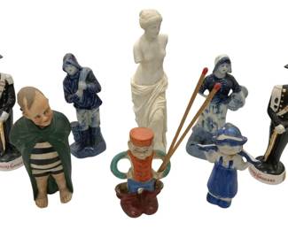 968 - Collection of Decorative Ceramic Figurines (Description): A collection of decorative ceramic figurines  featuring a variety of subjects. The grouping  includes a pair of Liquore Galliano soldier  decanters in formal military dress with  bicorn hats, a white bisque Venus de Milo reproduction, several blue and white  Delft-style Dutch figures, a kneeling figure  in green coat with striped pants, and a small  seated figure holding what appears to be a  match holder.