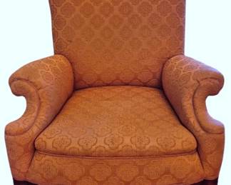 608 - Upholstered Club Chair w/ Claw Feet (Description): Vintage upholstered club chair featuring  elegant rolled arms and a high back. The  chair is covered in a damask fabric with a  medallion pattern. It rests on a mahogany  base with carved claw feet, characteristic of traditional English and American furniture  styles. Measures 34 inches high by 31 inches  wide by 31 inches deep.