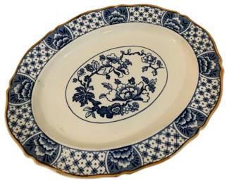 295 - Blue & White Floral Transferware Platter 12x9 (Description): Blue and white transferware platter featuring  a central floral medallion with peonies and  branches, surrounded by a cream ground. The  scalloped edge is decorated with an  alternating lattice and peony motif, finished with a gilt rim.