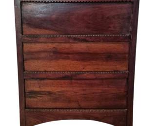 3721 - Antique Wooden Podium 29.5"x21"x13" (Description): Antique wooden podium featuring a rich dark  wood construction with decorative sawtooth  carved trim details across the front panel  sections. The piece displays three horizontal  panels with carved zigzag edging and stands on tapered legs with an arched apron at the  base. The top surface shows a beveled edge.