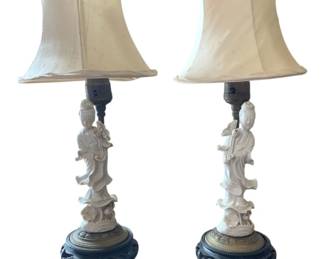 1339 - Pr Blanc de Chine Guanyin Figure Lamps 15" (Description): Pair of blanc de chine porcelain table lamps  featuring standing Guanyin figures in flowing  robes. Each white glazed figure is mounted  on a carved wooden base with brass collar.  The lamps are fitted with cream silk pagoda-style shades. Measures 15 inches tall. Used as is electric/electronic/mechanical  item. No guarantee all components, untested.