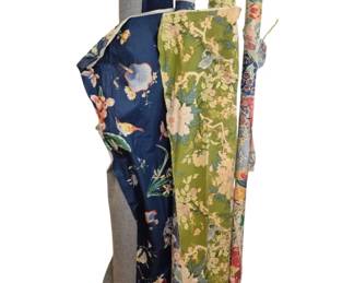 1288 - 4 Bolts Decorative Fabric Floral & Solid (Description): Collection of four 61" bolts of decorative  fabric featuring a variety of patterns.  Includes an Asian-inspired floral print on  navy blue background with birds and cherry  blossoms, a green floral chinoiserie pattern with birds and flowering branches, additional  colorful floral prints, and solid fabric.