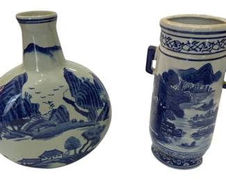 978 - 2 Blue & White Porcelain Vases 10"x4" (Description): Blue and white porcelain vases featuring  traditional Chinese landscape scenes with  mountains, trees, and pagodas. The set  includes a globular bottle vase with a narrow  neck and a cylindrical vase with squared handles at the shoulders. Both pieces display  hand-painted scenic decoration in cobalt  blue on a white ground. Measures 10 inches.