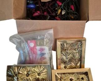 4069 - Vtg Christmas Lights & Tinsel Ornaments (Description): Vintage Christmas lights and tinsel  collection featuring a box of multicolored C9  style bulbs in various colors including  blue, pink, amber, and frosted white, with  original General Electric Translucent Color Lamps packaging visible. Also includes  several boxes of gold tinsel starburst  ornaments in original packaging, along with  additional holiday decorating supplies.