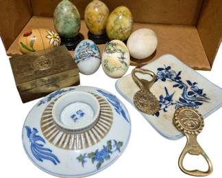 4190 - Group Lot of Oriental Decorative Items (Description): A group lot of Oriental decorative items  including stone eggs on stands, painted  decorative eggs, a brass trinket box with  engraved design, a porcelain lid with blue  and gold decoration featuring Chinese characters, a ceramic tile with blue floral  and bird motif, and brass bottle openers with  medallion designs.