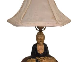 4003 - Vtg Cast Iron Buddha Lamp w/ Base 18" (Description): Vintage cast iron Buddha lamp featuring a  seated Buddha figure in meditation pose. The  figure is finished in gold and black tones,  with gold-toned skin and a black robe. The  lamp includes the original harp, vintage shade and wood base. Measures 18 inches in  height. A distinctive decorative accent piece  with Asian-inspired styling. Used as is electric/electronic/mechanical  item. No guarantee all components, untested.