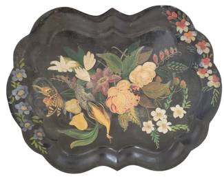 435 - Antique Hand Painted Tole Tray 19.5"x20" (Description): Antique hand painted tole tray featuring a  central floral bouquet with roses, lilies,  and various blooms in vibrant colors against  a black background. A butterfly and bird  accent the botanical arrangement, with additional floral sprays decorating the  scalloped border. The tray has a  characteristic wavy, scalloped edge typical  of Victorian-era tole ware. Measures 19.5" x  20".