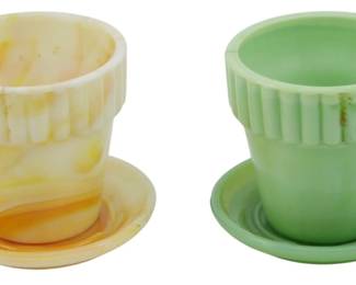 1878 - 2 Akro Agate Miniature Glass Flower Pots 3" (Description): Two Akro Agate miniature glass flower pots  with attached saucers. One pot features a  marbled cream, orange, and yellow slag glass  pattern, while the other is in a solid jade  green color. Both pots have ribbed sides. Each measures 3 inches.