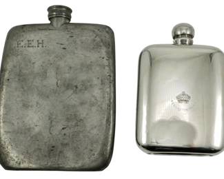129 - 2 Sheffield Plate Liquor Flasks 7" (Description): Two Sheffield plate flasks, one featuring  engraved initials "E.E.H." and the other  bearing a crown emblem with "Kensington  Palace" inscription. Measures 7 inches.