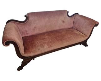 1262 - Victorian Style Mahogany Sofa 37"x86"x30" (Description): Victorian style sofa featuring an elegant  serpentine back with carved mahogany frame.  The piece is upholstered in dusty rose velvet  and displays gracefully scrolled arms with  carved wooden trim. The sofa rests on carved cabriole feet with decorative detailing.  Measures 37 inches high by 86 inches wide by  30 inches deep.