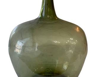 641 - Vintage Green Wine Bottle 19.5"x14"x11" (Description): Green glass bottle with a bulbous body and  tapered neck. Measures 19.5 inches tall by 14  inches wide by 11 inches deep.