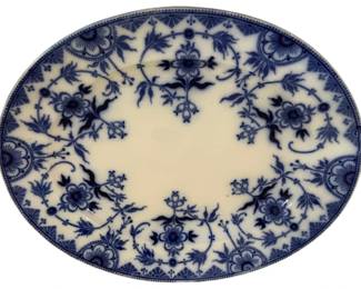 322 - Burgess & Leigh Harlem Blue/White Platter (Description): Burgess & Leigh oval platter in the Harlem  pattern, featuring classic blue and white  transferware decoration. The design showcases  an intricate floral motif with stylized  blossoms, scrolling vines, and geometric border elements in deep cobalt blue against a  white ground. Corner medallions with  fan-like ornamental details accent the  scalloped rim. This elegant Victorian-era  piece measures 17 inches by 14.5 inches.