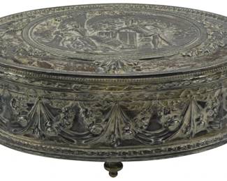879 - Silver Plated Jewelry Box Marked "JB" (Description): Silver plated jewelry box marked "JB". The  oval-shaped box features ornate repousse  decoration with classical figural scenes on  the lid and decorative swags and floral  motifs around the sides. Measures 3 inches high by 8 inches wide by 6 inches dee.