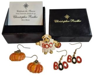 1998 - Christopher Radko Boo Bear Pin & Earrings (Description): Christopher Radko Halloween jewelry set  featuring the Boo Bear pin and coordinating  earrings. The enameled pin depicts a teddy  bear in a ghost costume holding a pumpkin,  with "BOO" spelled across the front in red rhinestones. The set includes two pairs of  pierced earrings: orange enameled pumpkins  and red "BOO" letter dangles. Comes with  original Christopher Radko box and card.