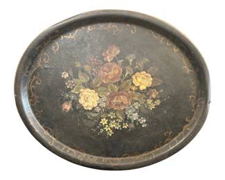 542 - Tole Metal Large Serving Tray 28"x23" (Description): Large tole metal serving tray featuring a  hand-painted floral bouquet at center with  roses, hydrangeas, and other blossoms in soft  pink, yellow, cream, and blue tones against  a dark green-black ground. The raised rim is decorated with gilt scrollwork borders. The  tray shows a lovely aged patina consistent  with its antique character. Measures 28  inches by 23 inches.