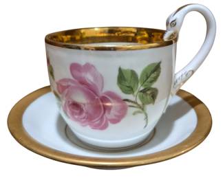 4191 - Meissen Porcelain Cup & Saucer w/ Pink Rose (Description): Meissen porcelain cup and saucer featuring  hand-painted pink rose decoration. The cup  has a gilt interior and gilt rim, with an  elegant scrolled swan handle. The saucer  features a wide gilt band around the edge. Classic Meissen quality with floral motif on  white porcelain ground.