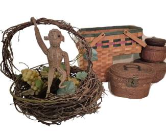 3792 - Group of Assorted Woven Baskets w/ Monkey (Description): A charming group of assorted baskets  including a rustic grapevine basket with  arched handle featuring a woven monkey figure  and faux grapes, a colorful woven  picnic-style basket with leather straps and green trim, and three small lidded rattan  storage baskets with brass clasps. One basket  is broken. A decorative collection suitable  for display or storage.