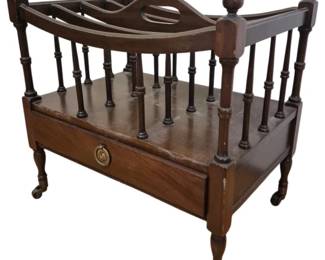 1279 - Vintage Mahogany Canterbury Magazine Rack (Description): Vintage mahogany Canterbury magazine rack  featuring turned spindle dividers with acorn  finials at each corner. The piece includes a  single drawer with a brass ring pull and  rests on turned legs with original brass casters. This classic English-style  Canterbury is ideal for storing newspapers,  magazines, or sheet music. Measures  19"x13"x19".