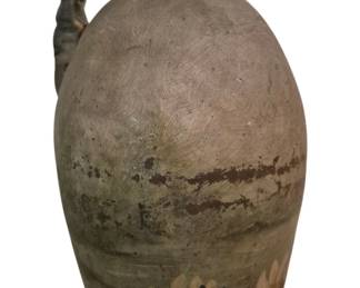 3986 - Antique Stoneware Jug w/ Painted Lily Motif (Description): Antique stoneware jug featuring a  hand-painted decorative water lily and grass  motif around the lower portion. The vessel  has a classic ovoid form with a narrow neck  and applied loop handle. The surface shows characteristic scratched texture and a  weathered patina with areas of green, brown,  and earth-toned coloring from age and use.