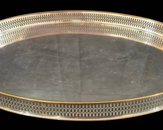 508 - Manning Bowman Large Oval Tray 23.5"x13" (Description): Manning Bowman large oval serving tray  featuring an elegant pierced gallery rim with  a decorative reticulated pattern. The tray  has a silver plate finish with gilt accent  banding along the gallery edge and features distinctive angular handles with wood or  bakelite grips. The smooth center surface  shows gentle patina consistent with age and  use. This handsome piece exemplifies the  quality craftsmanship Manning Bowman was