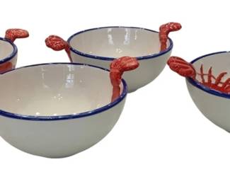 1221 - 4 Ceramic Lobster Bowls w/ Blue Rim (Description): Set of four ceramic petal bowls featuring a  nautical lobster motif. Each white bowl is  decorated with red lobster designs and  accented with a blue rim. The bowls include  dimensional lobster claw handles extending from the sides, adding a whimsical coastal  touch to the set.