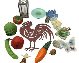 950 - Lot of Assorted Decorative Items (Description): A lot of assorted decorative items including  papier-mache vegetables (cucumber, apple,  cabbage, tomato, and carrot), a metal cut-out  rooster wall hanging, a small glass and  metal lantern candle holder, ceramic wall pockets with vegetable and butterfly motifs,  a small brass bell with decorative figure,  and assorted ceramic figurines. A varied  collection suitable for home decor.