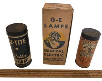 2782 - Vintage Car Advertising Collection (Description): Group of vintage automotive advertising items  including an X-Tite Rubber Repair Kit, a  General Electric G-E Lamps box from Nela Park  in Cleveland, Ohio, a Dutch Brand Sure-Seal  Patch Outfit, and an Amoco Gas wooden advertising ruler. The collection represents  early to mid-20th century automobile-related  ephemera and packaging.