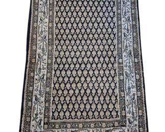 2803 - Hand-Knotted Persian Style Area Rug (Description): Hand-knotted Persian style area rug featuring  a classic Mir Boteh (paisley) pattern on a  dark navy field. The central field displays  rows of small boteh motifs in cream and tan  tones, surrounded by multiple decorative borders with floral and geometric designs in  coordinating colors. The rug has ivory and  navy borders with traditional scrolling vine  patterns. Features original fringe at both  ends. The rug appears to be in good vintage