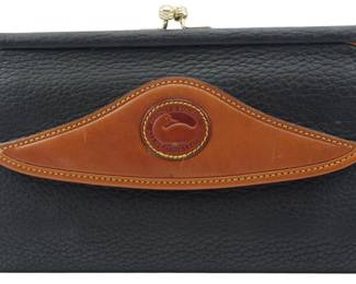 1833 - Dooney & Bourke Leather Wallet 4.5"x7" (Description): Dooney & Bourke leather wallet in black  pebbled leather with tan leather trim and the  signature duck medallion on the front flap.  Features a kiss-lock closure at the top.  Measures 4 1/2 inches by 7 inches.