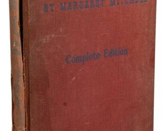 828 - 1940 Motion Picture Ed. Gone w/ the Wind (Description): 1940 Motion Picture Edition of Gone with the  Wind by Margaret Mitchell. This complete  edition was published to coincide with the  famous film adaptation. The book features a  cloth-covered hardcover binding.