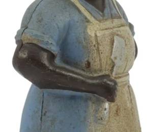 1701 - Vintage Cast Iron Aunt Jemima Coin Bank 6" (Description): Vintage cast iron Aunt Jemima coin bank  featuring original polychrome paint. The  figure depicts a woman wearing a blue dress  with a cream-colored apron and a decorative  headwrap. Measures 6 inches tall.