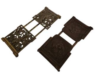 3928 - Brass & Bronze Adjustable Book Racks (Description): A pair of antique adjustable book holders in  brass and bronze. One features an ornate  openwork design with scrolling foliate  patterns, while the other displays embossed  floral medallions on solid panels. Both expand to accommodate books of various sizes  and feature decorative Arts and Crafts style  detailing.