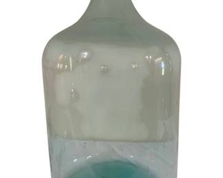 414 - Large Green Glass Wine Bottle 26"x13" (Description): Large green glass wine bottle with a classic  carboy style shape. This substantial piece  features a narrow neck and wide body, typical  of traditional wine storage vessels.  Measures 26 inches tall by 13 inches wide. with crack
