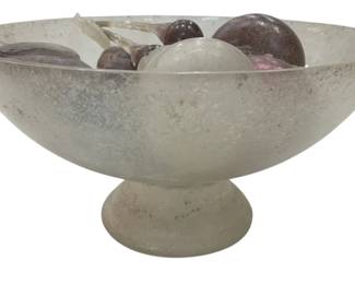 976 - Frosted Glass Pedestal Bowl w/ Glass Fruit (Description): Frosted glass pedestal bowl with decorative  glass fruit. The footed compote-style bowl  has a silvery, textured finish and contains  an assortment of glass fruit including  spheres and organic shapes in muted purple and white tones. Measures 14.5 x 7.5 inches.